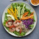 <p>All the tastes, color and fun of a spring roll without all the work! This healthy salad recipe is bursting with the colors of rainbow from generous amounts of fresh vegetables, shrimp and whole grains all topped with a peanut dressing for the ultimate satisfying salad. <a href="https://www.eatingwell.com/recipe/256969/spring-roll-salad/" rel="nofollow noopener" target="_blank" data-ylk="slk:View Recipe;elm:context_link;itc:0;sec:content-canvas" class="link ">View Recipe</a></p>