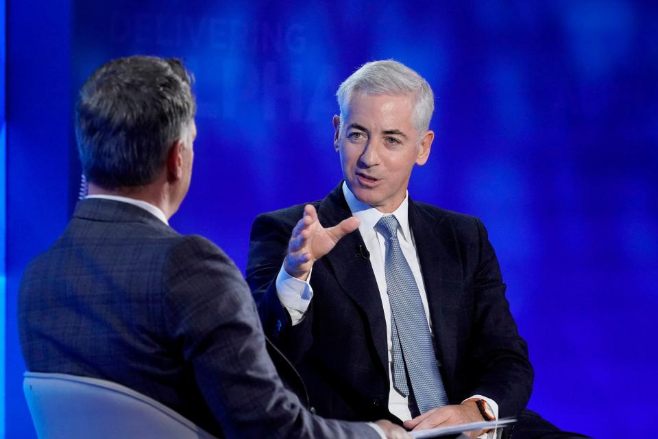 Bill Ackman gesturing while seated at CNBC's Delivering Alpha conference.