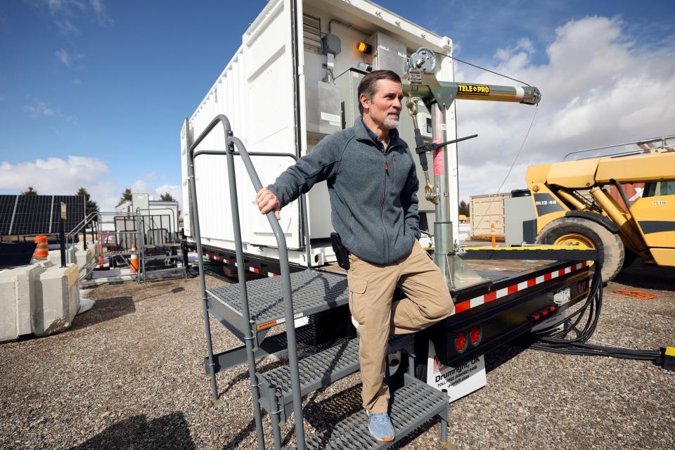 Kurt Myers, Idaho National Laboratory distributed energy and grid systems integration group lead, walks away from a portable shipping container that is part of a microgrid, connected to solar panels, after checking a meter on it outside of the INL Energy Systems Laboratory in Idaho Falls, Idaho, on Wednesday, April 5, 2023. | Kristin Murphy, Deseret News