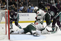 Anaheim Ducks center Leo Carlsson (91) shoots wide of the net with Minnesota Wild goaltender Filip Gustavsson (32) and defenseman Zach Bogosian (24) defending during the first period of an NHL hockey game in Anaheim, Calif., Tuesday, March 19, 2024. (AP Photo/Alex Gallardo)