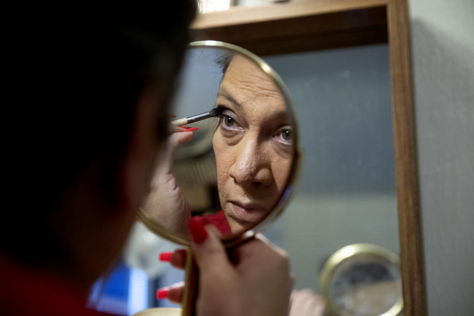 Christina Wood applies makeup and gets ready before going to work in her home in Salem, Ore., Friday, April 21, 2023. Six years ago Wood moved to Oregon, where she could access the gender-affirming health care she needed to live as her authentic self. Once there, Wood, was able to receive certain surgeries that helped her transition, but electrolysis, or permanent hair removal, wasn’t fully covered under the state’s Medicaid plan for low-income residents. Paying out-of-pocket ate up nearly half her monthly income, but it was critical for Wood's mental health. (AP Photo/Amanda Loman)