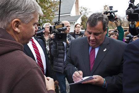 New Jersey Governor Chris Christie (R) signs autographs for supporters as he leaves a polling station after casting his vote during the New Jersey governor election in Mendham Township, New Jersey, November 5, 2013. REUTERS/Eduardo Munoz