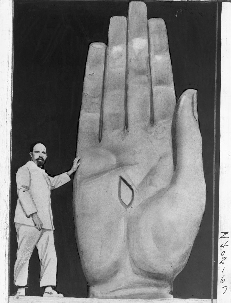 Polish sculptor, shown at work on the hand of the giant statue of Christ which he is completing and which will be placed in Rio De Janeiro Bay, South America.