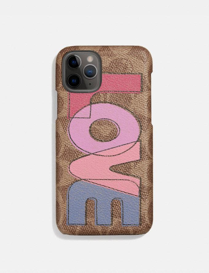 Iphone 11 Pro Case In Signature Canvas With Love Print. Image via Coach.