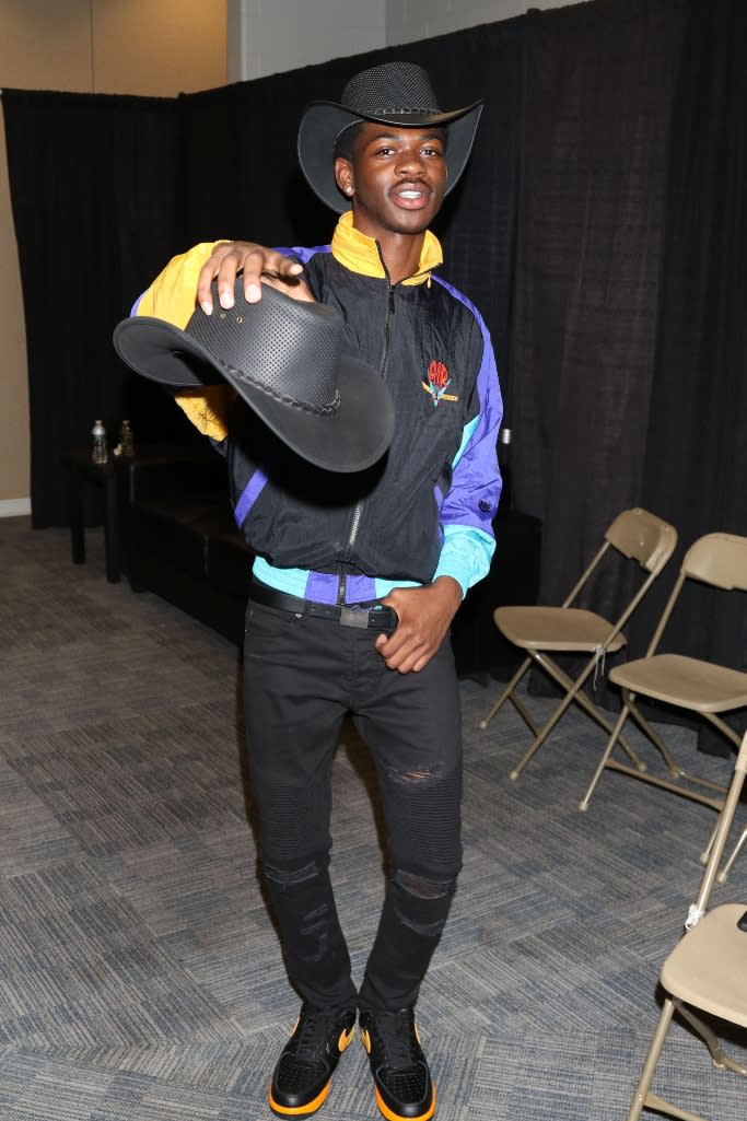 Lil Nas X sporting an Air Jordan windbreaker with black and orange Nike AF1 sneakers at Hot 97’s Summer Jam music festival. - Credit: Shutterstock