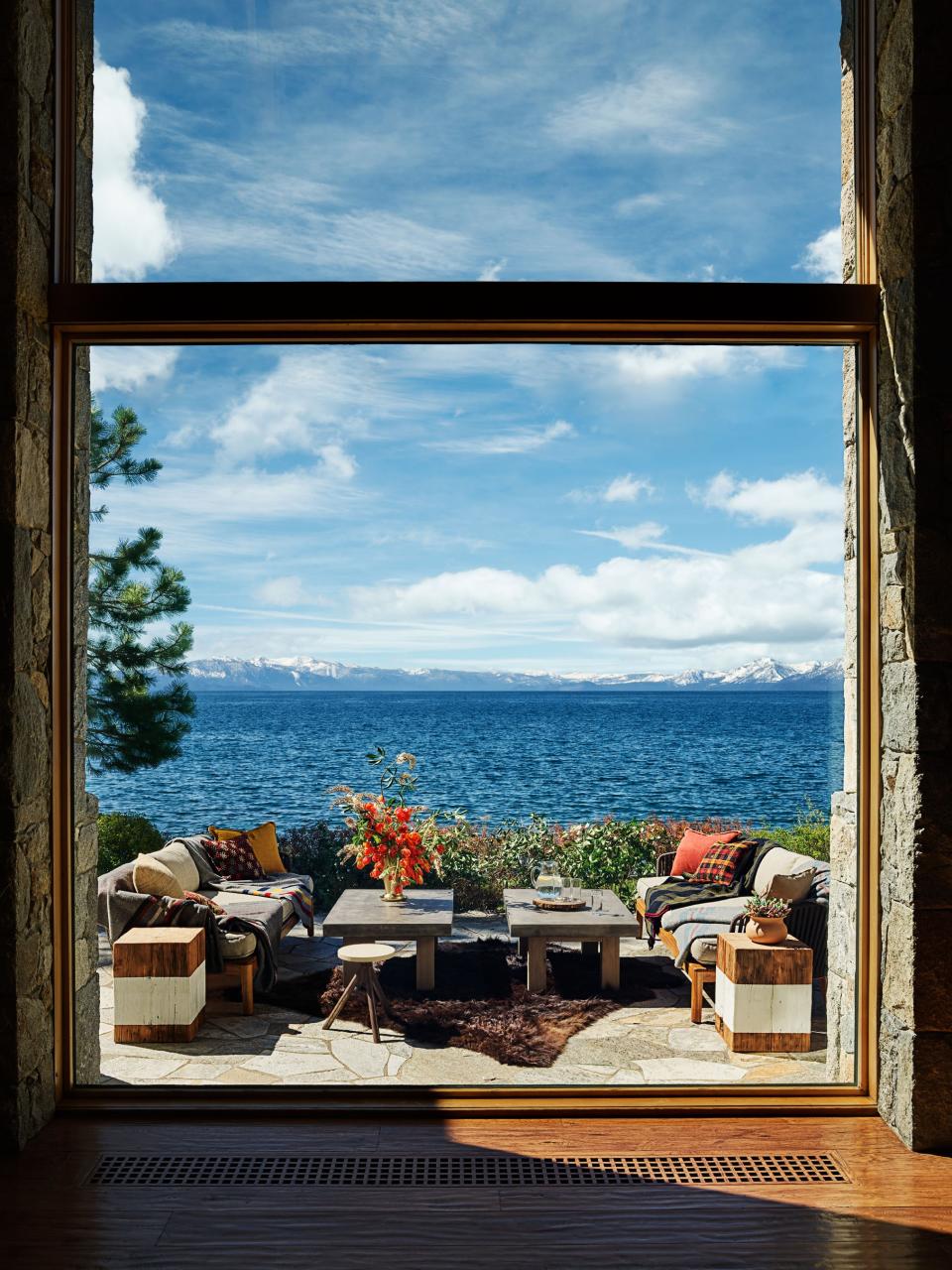 The outdoor living room looks south over Lake Tahoe. Janus et Cie sofas; RH cocktail tables; reclaimed wood side tables from Dos Gallos.