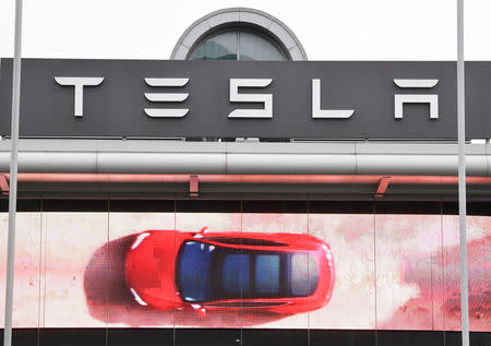 An advertising screen is seen outside a Tesla showroom in west London, Britain, March 1, 2019. REUTERS/Toby Melville