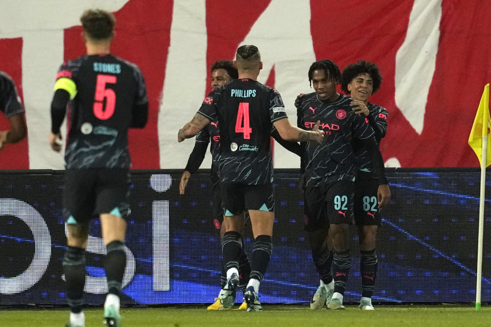 Manchester City's Micah Hamilton, second right, is congratulated by teammates after scoring opening goal during the Group G Champions League soccer match between Red Star and Manchester City, at the Rajko Mitic Stadium in Belgrade, Serbia, Wednesday, Dec. 13, 2023. (AP Photo/Darko Vojinovic)