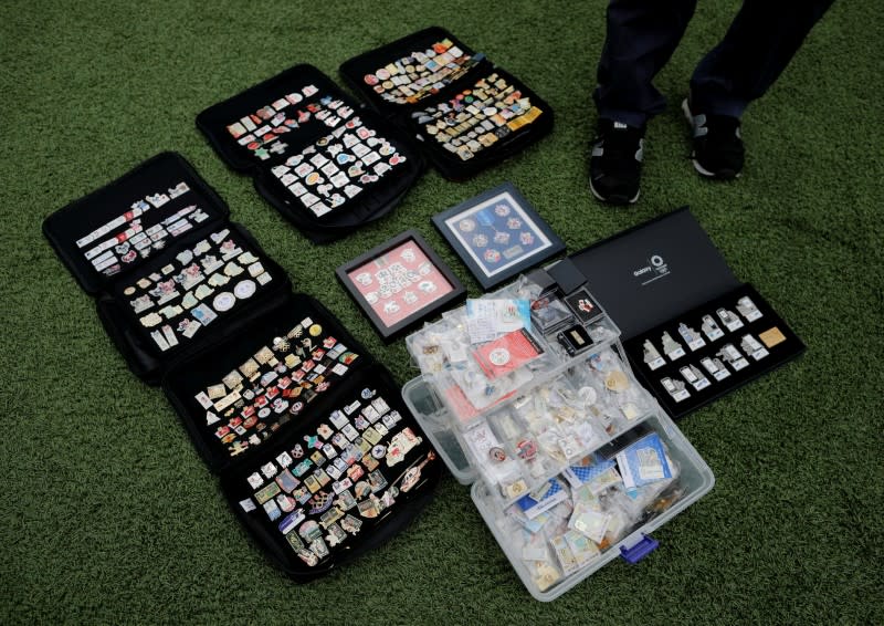 Yoshiyuki Terajima, a pin collector based in Tokyo, displays his Olympic pin collection near the National Stadium in Tokyo