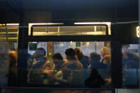 Commuters stand in a bus, in Paris, Wednesday, Dec. 11, 2019. After hundreds of thousands of angry protesters marched through French cities, the prime minister is expected to unveil proposals that might calm tensions on the 7th straight day of a crippling transport strike. (AP Photo/Thibault Camus)