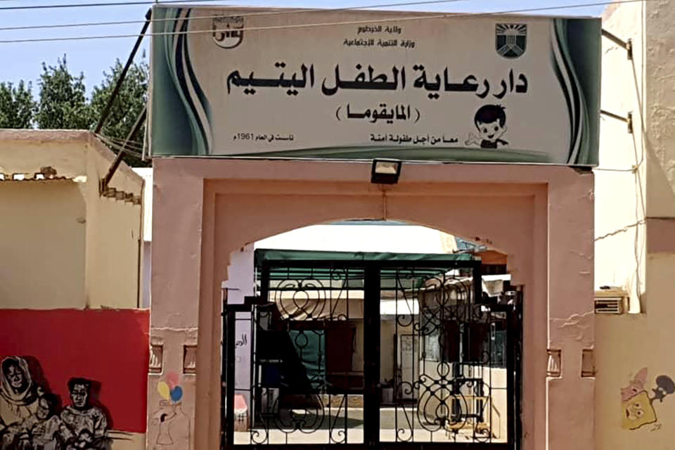 The closed entrance gate of the Foster Home for Orphans is seen in Khartoum, Sudan, May 2023. At least 60 infants, toddlers and older children perished over the past six weeks while trapped in horrific conditions in the orphanage in Sudan's capital as fighting raged outside. (AP Photo/Nazim Sirag)