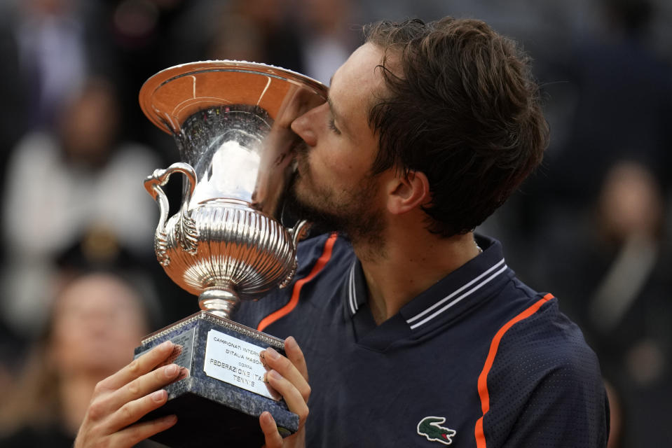 Daniil Medvedev of Russia kisses the trophy after defeating Denmark's Holger Rune during the men's final tennis match at the Italian Open tennis tournament in Rome, Italy, Sunday, May 21, 2023. (AP Photo/Alessandra Tarantino)