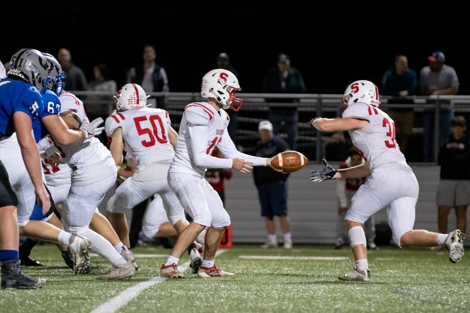 Souderton quarterback Nate Hageman hands off to fullback Chris Kerns during a game against Quakertown at Alumni Memorial Field on Friday, October 1, 2021. The Panthers continue their undefeated season with a 36-14 win over Souderton.