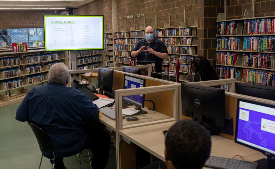 Matthew Scheich, a technical training associate, leads a genealogy researching class inside the Detroit Public Library Redford Branch in Detroit on Nov. 21, 2023. The Finding Your Roots class teaches library members how to use an online database through the Detroit Public Library to research their ancestry.