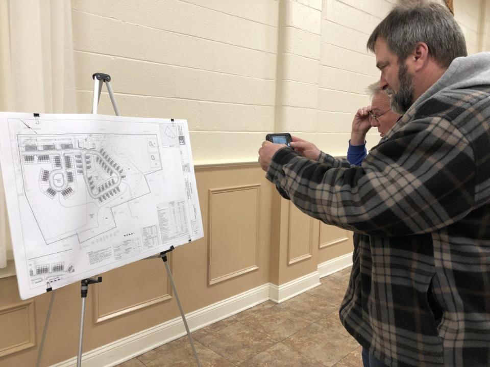 Hulmeville area residents take photos and inspect the plans for Superior Holdings' proposed housing development in the borough which should have 38 single family homes, 49 townhomes and 33 apartments.  The plan was presented to the public at a planners meeting in the William Penn Fire Co. Hall in Hulmeville Wednesday evening.