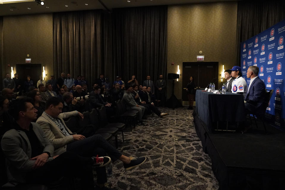 New Chicago Cubs pitcher Shōta Imanaga takes part in a news conference along with interpreter Shingo Murata, left, and Cubs president of baseball operations Jed Hoyer, right, Friday, Jan. 12, 2024, in Chicago. The Japanese left-hander is expected to step right into the baseball team's rotation as it tries to return to the playoffs for the first time since 2020. (AP Photo/Nam Y. Huh)