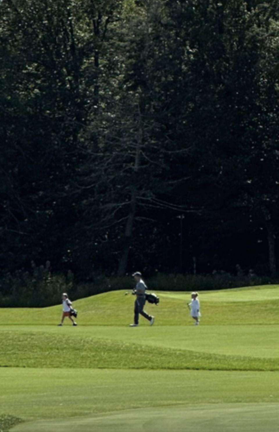 Robert Herjavec and kids Haven and Hudson play golf on golf course