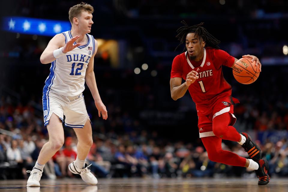 North Carolina State guard Jayden Taylor (1) drives to the basket as Duke Blue Devils forward TJ Power (12) defends in the first half Thursday at Capital One Arena in Washington.