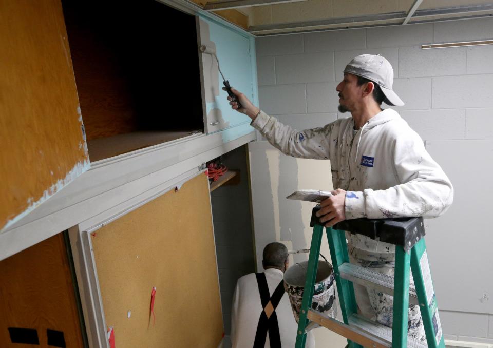 Juan Ortiz of Carlos Ortiz Painting applies paint Tuesday, Jan. 24, 2023, at the former Tarkington Elementary School building on Hepler Street in South Bend. The school building will become the new Paramount School in the fall.