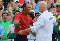 Tiger Woods (L) of the United States celebrates with caddie Joe LaCava (R) on the 18th green after winning during the final round of the Masters at Augusta National Golf Club on April 14, 2019 in Augusta, Georgia. (Photo by David Cannon/Getty Images)