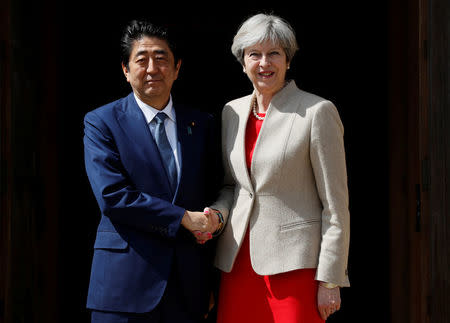 Britain's Prime Minister Theresa May greets Prime Minister Shinzo Abe of Japan during a visit to Chequers, near Wendover, Britain April 28, 2017. REUTERS/Kirsty Wigglesworth/Pool