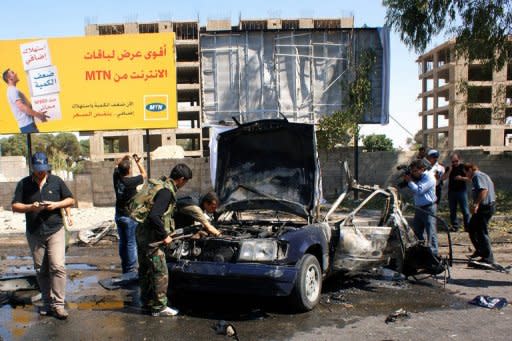 Picture released by the official Syrian Arab News Agency (SANA) July 13, shows police inspecting the site of a car bomb explosion on Mazzeh highway in the capital Damascus. Peace envoy Kofi Annan said Syria had "flouted" Security Council resolutions with mass killings in Treimsa village, as UN chief Ban Ki-moon demanded that the Council act to stop the bloodshed