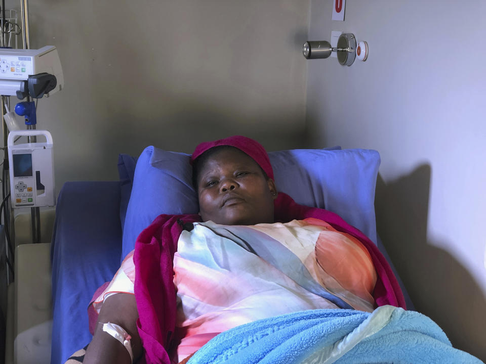 Comedian Samantha Kureya lays in her hospital bed in Harare, Thursday, Aug. 22, 2019. Kureya was abducted from her home, stripped naked and tortured by masked men with assault rifles, for performing skits perceived as being anti-government, the latest in a string of alleged abductions of government critics. (AP Photo/Tsvangirayi Mukwazhi)