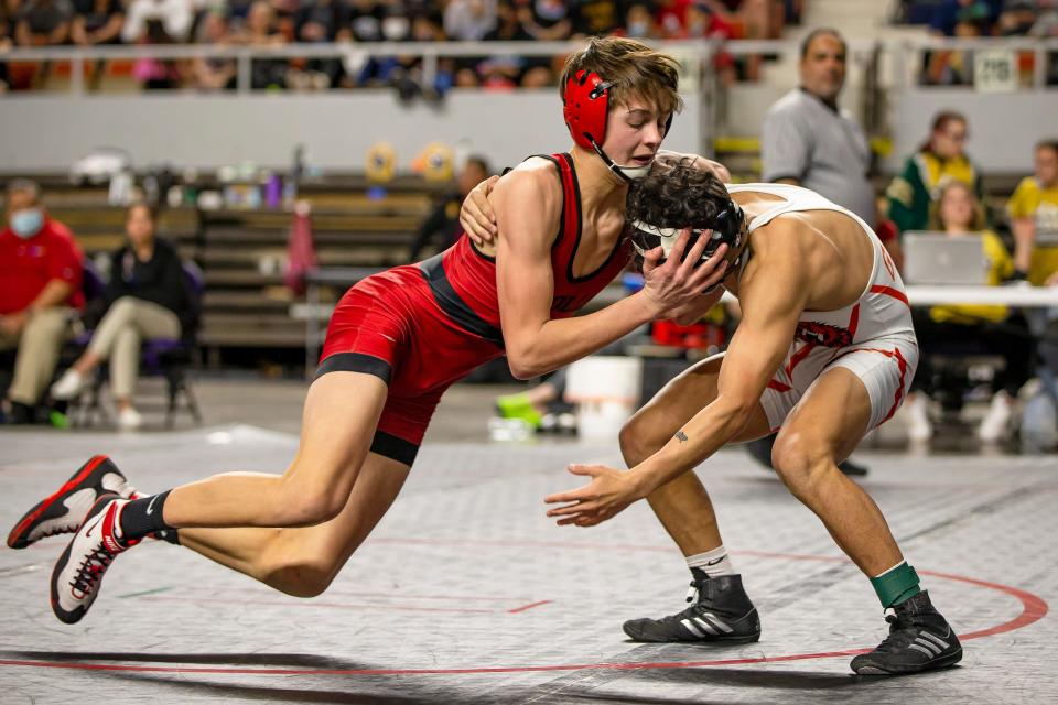 Divison IV wrestlers from Globe and Mollogon engage in a match during the AIA state wrestling championships in the Arizona Veterans Memorial Coliseum in Phoenix on Feb. 19, 2022. Monica D. Spencer/The Republic 6869573001