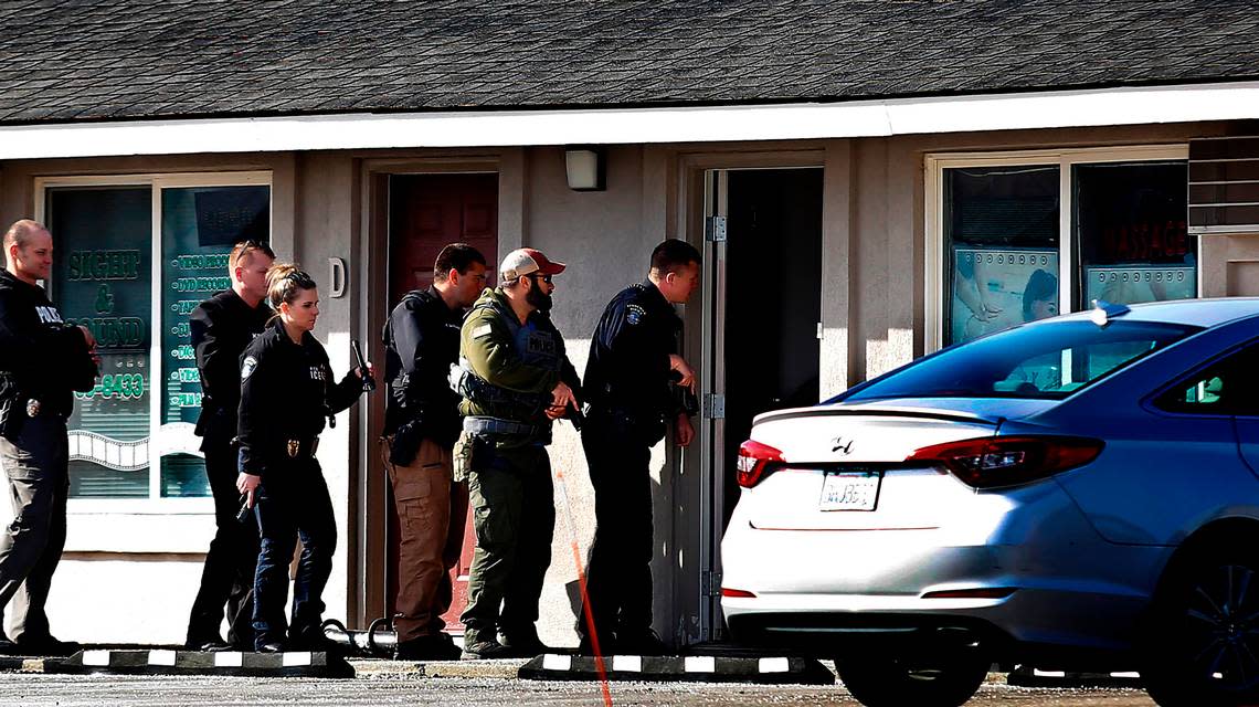 Kennewick police help federal agents search a massage business at 6201 West Clearwater Ave. Wednesday morning in Kennewick. The effort was part of a larger series of searches across Washington state focused on human trafficking, said Kennewick Sgt. Chris Littrell. bbrawdy@tricityherald.com