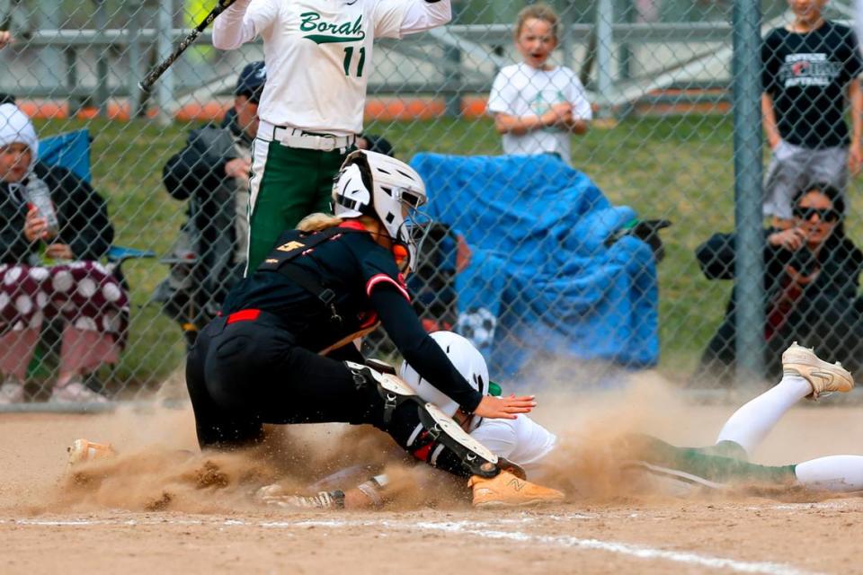 Borah’s Rylee Nelson slides safely into home against Owyhee in the 5A state championship game May 17 at Post Falls High.