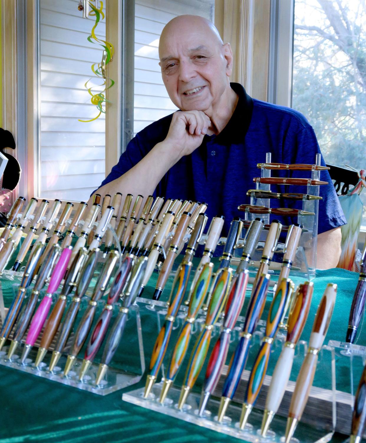 Paul DeSaro is shown Tuesday, January 2, 2023, with some of the "Exotic Wood Pens" he has created in his Middletown home. He uses wood sourced from all over the world.