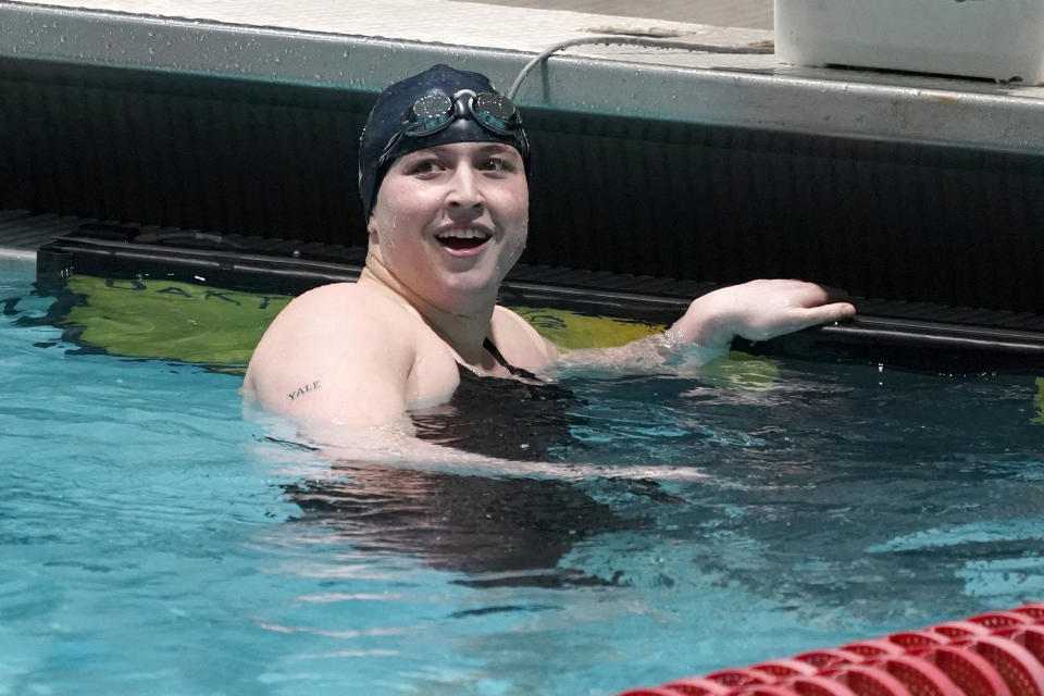 FILE - Yale's Iszac Henig, a trans man and competitive swimmer, looks up the scoreboard after swimming in a qualifying heat of the 100-yard freestyle at the Ivy League Women's Swimming and Diving Championships at Harvard University, Feb. 19, 2022, in Cambridge, Mass. Schools and colleges across the U.S. would be forbidden from enacting outright bans on transgender athletes under a proposal released Thursday, April 6, 2023, by the Biden administration, but teams could create some limits in certain cases — for example, to ensure fairness. (AP Photo/Mary Schwalm, File)