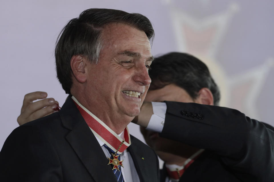 Brazil's President Jair Bolsonaro receives the Maua Merit Medal for services to the national infrastructure, in Brasilia, Brazil, Thursday, Aug. 15, 2019. (AP Photo/Eraldo Peres)