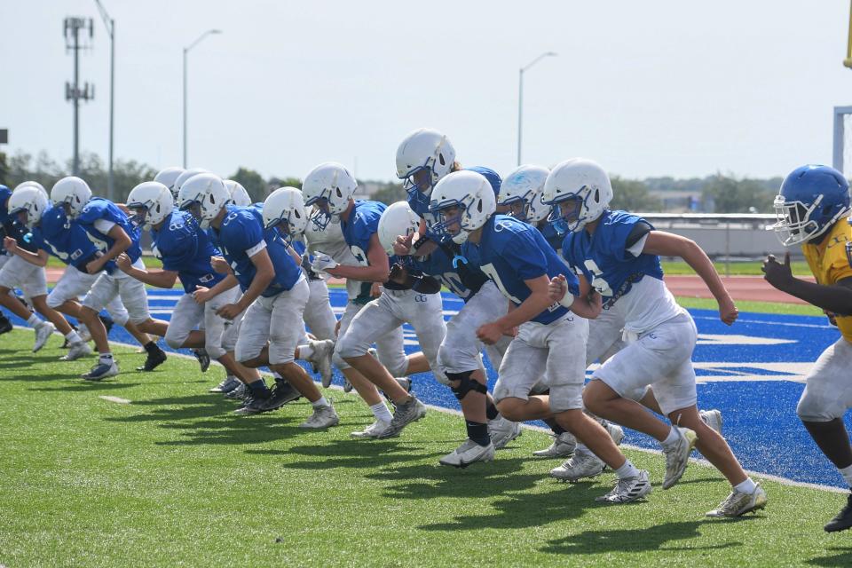 O'Gorman football players run laps at O'Gorman High School in Sioux Falls, South Dakota on Wednesday, August 16, 2023.