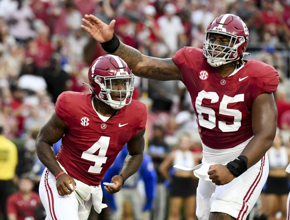 Sep 2, 2023; Tuscaloosa, Alabama, USA; Alabama Crimson Tide quarterback Jalen Milroe (4) celebrates with offensive lineman JC Latham (65) after scoring against the Middle Tennessee Blue Raiders during the first half at Bryant-Denny Stadium. Mandatory Credit: Gary Cosby Jr.-USA TODAY Sports