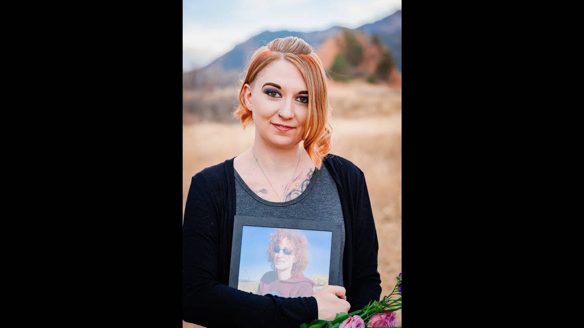 “She was such a fierce protector,” Tiffany Luna said of her late sister, Jo Acker, a Boise mall security guard who was shot and killed by a gunman on Oct. 25, 2021. Luna is seen here holding a photo of Acker. “I could call her at anytime and tell her a problem I was having, and she would want to come and fix it for me. And now I can’t do that. She’ll never meet my son. She’ll never see her daughter grow up.”