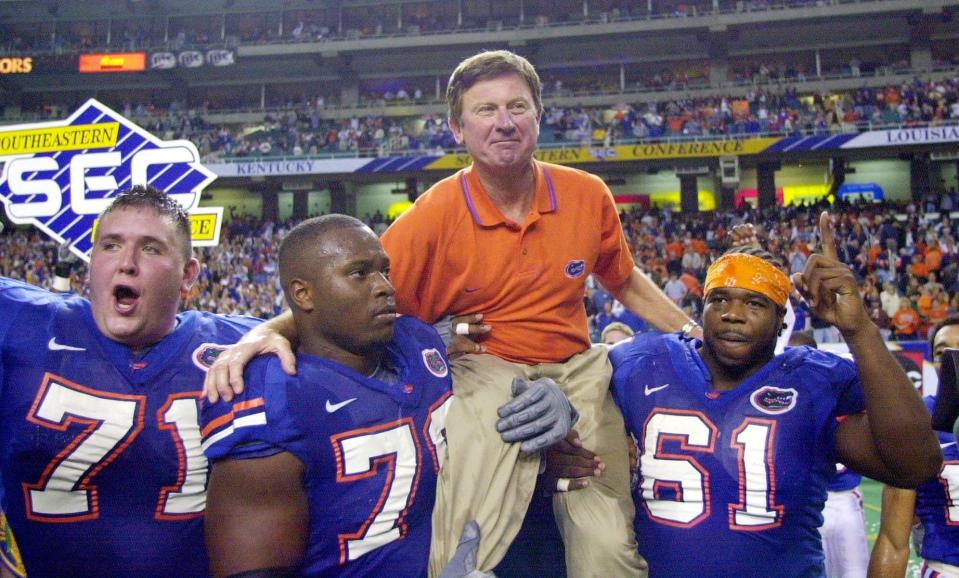 Florida head coach Steve Spurrier is carried off the field after the Gators downed Auburn 28-6 in the SEC Championship Dec. 2, 2000.