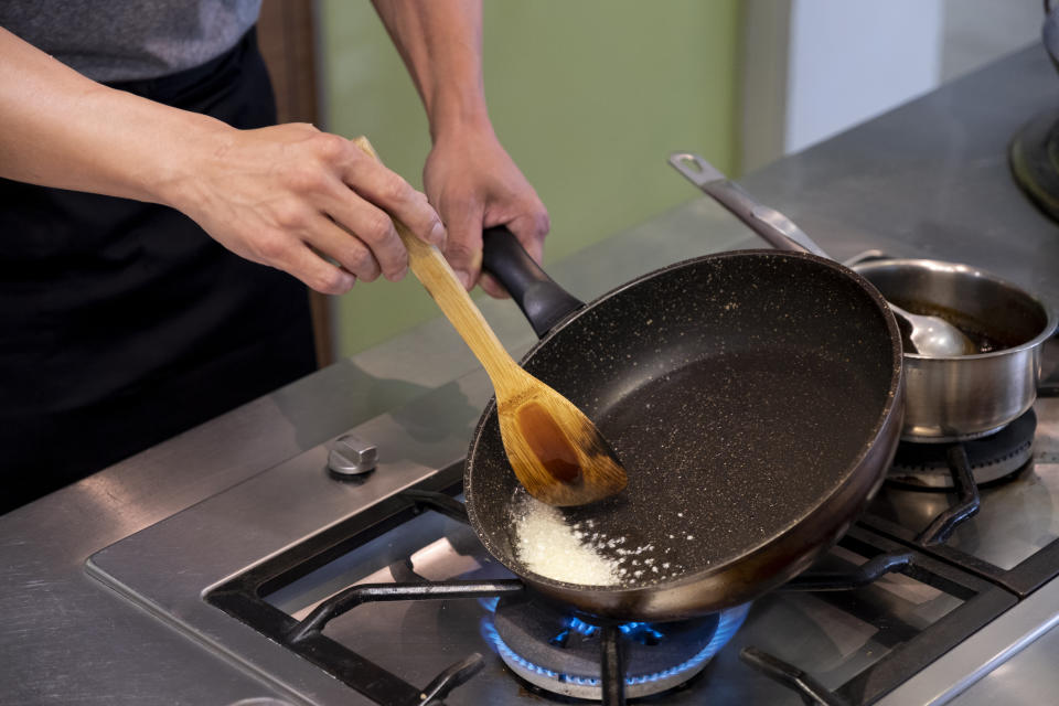 person heating up salt on their pan