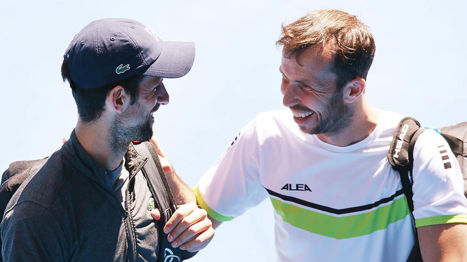 Novak Djokovic of Serbia, making a comeback from an elbow injury, is seen with Radek Stepanek of the Czech Republic (R) after a practice session ahead of the 2018 Australian Open. Pic: Getty