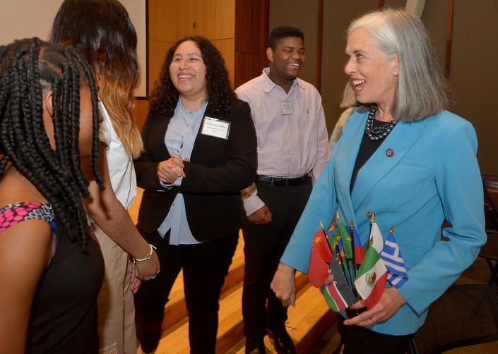 U.S. Rep. Katherine Clark, right, smiles after a fist bump with Framingham High School student Melanie Cerin Aldana, center, after Clark announced a $600,000 expansion of the MetroWest Scholars Early Start program, early college funding for Waltham students at Framingham State University, May 3, 2022. From left are Melody Obi-Ngo, of Waltham; Dayana Alvarado Perez, of Framingham; Aldana; Derrick Vervil, of Framingham; and Clark.