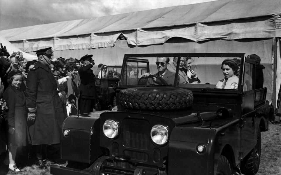 19th May 1955: The Duke of Edinburgh at the wheel of a Land Rover sets off for a tour of the course of the European Horse Trials at Windsor with The Queen  - Terry Disney/Central Press/Getty Images