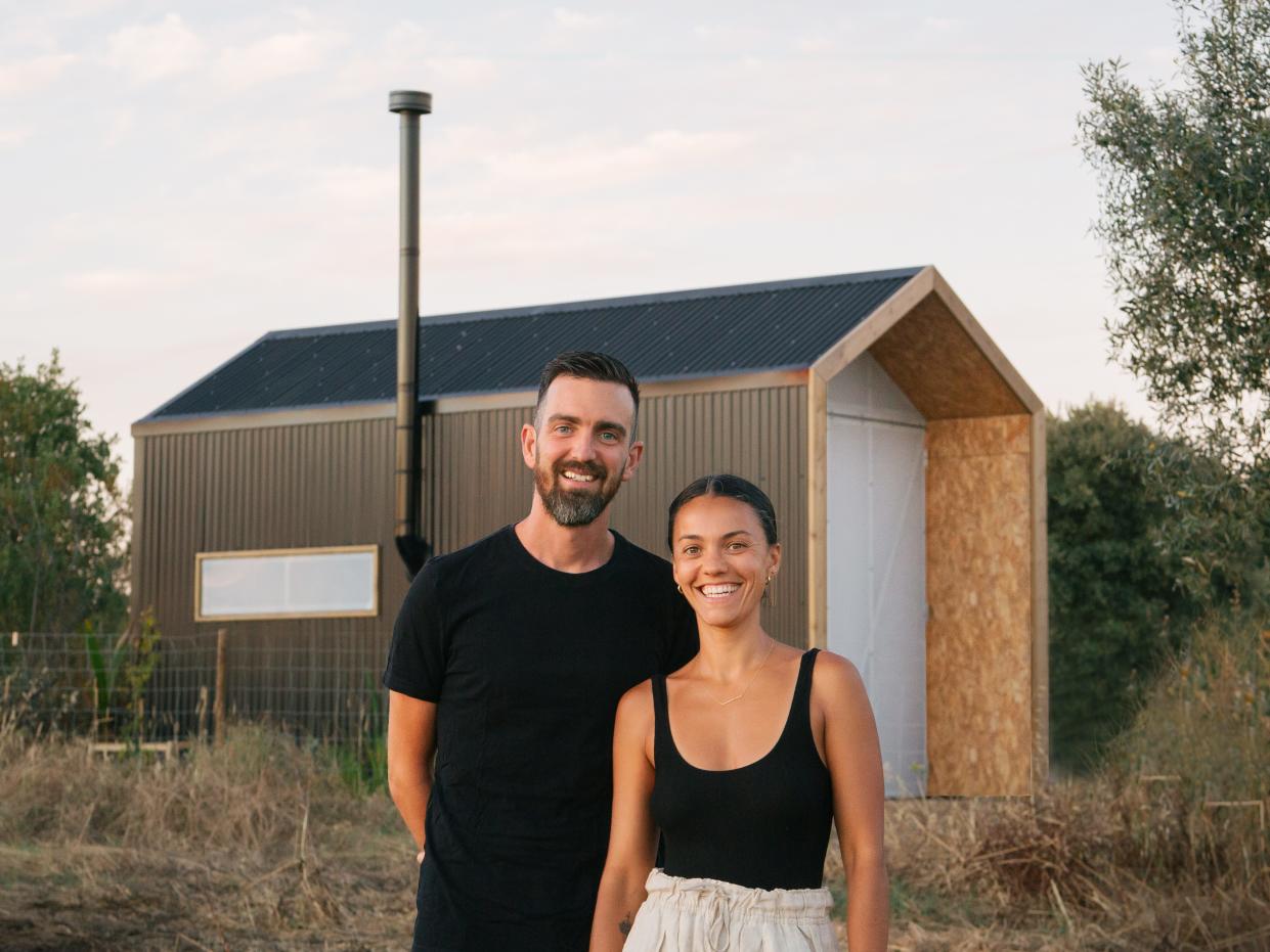 Pepe and Eugenia standing outside the completed cabin.