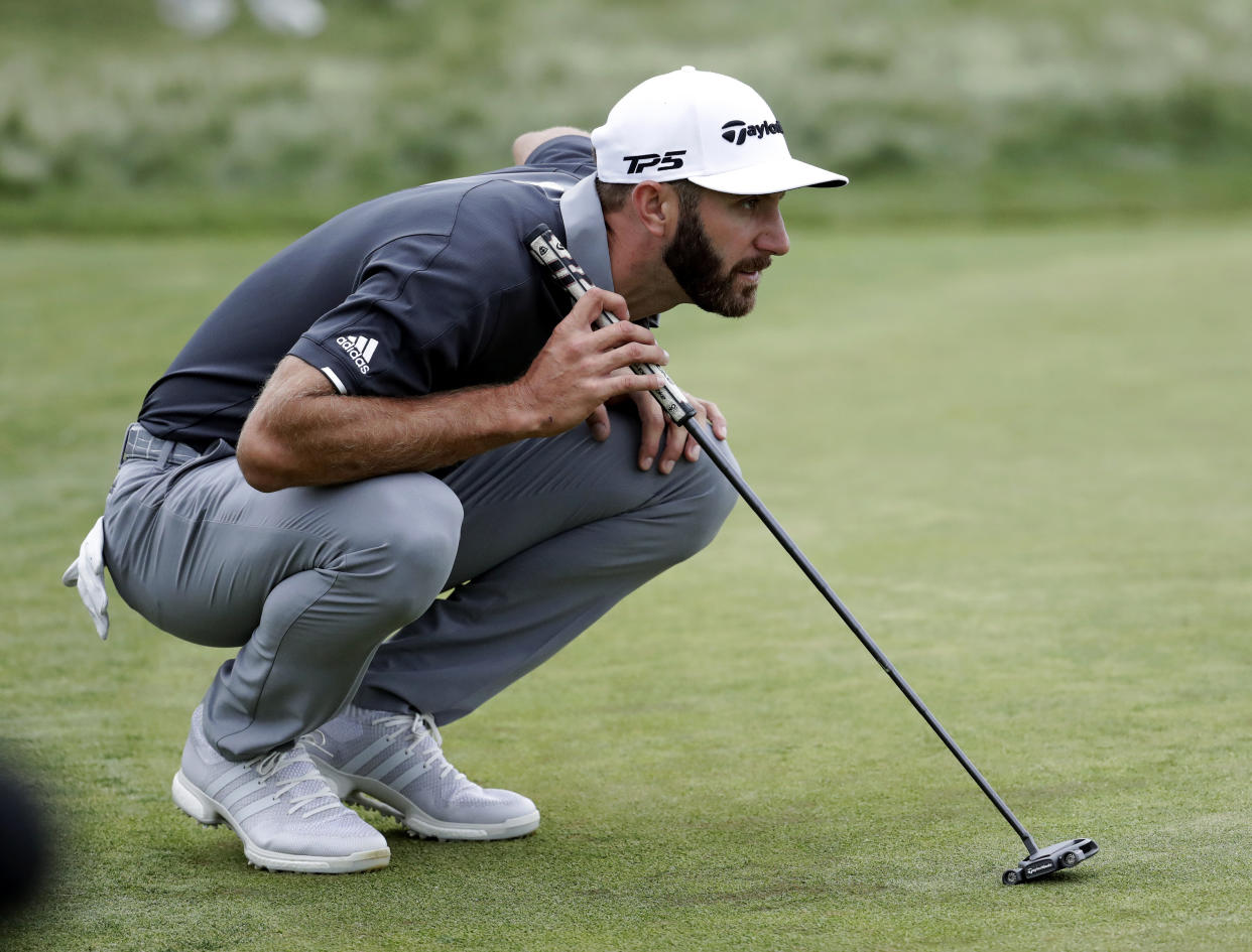 Dustin Johnson lines up a putt on Friday at the U.S. Open. (AP)