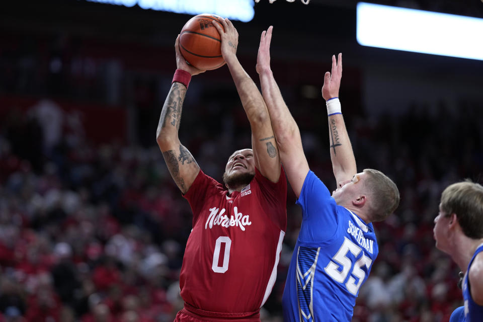 Nebraska guard C.J. Wilcher (0) drives to the basket past Creighton guard Baylor Scheierman (55) during the first half of an NCAA college basketball game, Sunday, Dec. 3, 2023, in Lincoln, Neb. (AP Photo/Charlie Neibergall)