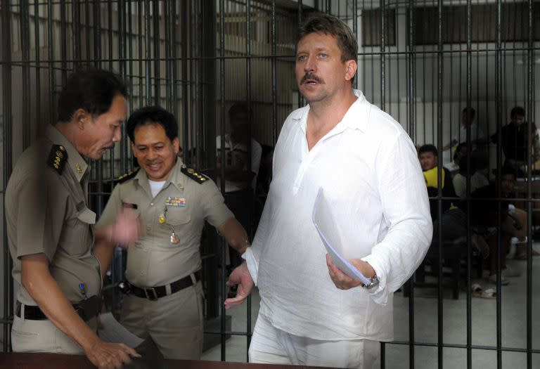 En esta foto de archivo tomada el 9 de abril de 2008, policías tailandeses se llevan al traficante de armas ruso Viktor Bout después de tomarle las huellas dactilares en el centro de detención del tribunal penal de Bangkok. Moscú confirmó el 8 de diciembre de 2022 que había intercambiado a la estrella del baloncesto estadounidense Brittney Griner, que había estado encarcelada en Rusia, por el notorio traficante de armas Victor Bout, que cumplía una condena de 25 años en los Estados Unidos. (Photo by Saeed KHAN / AFP)