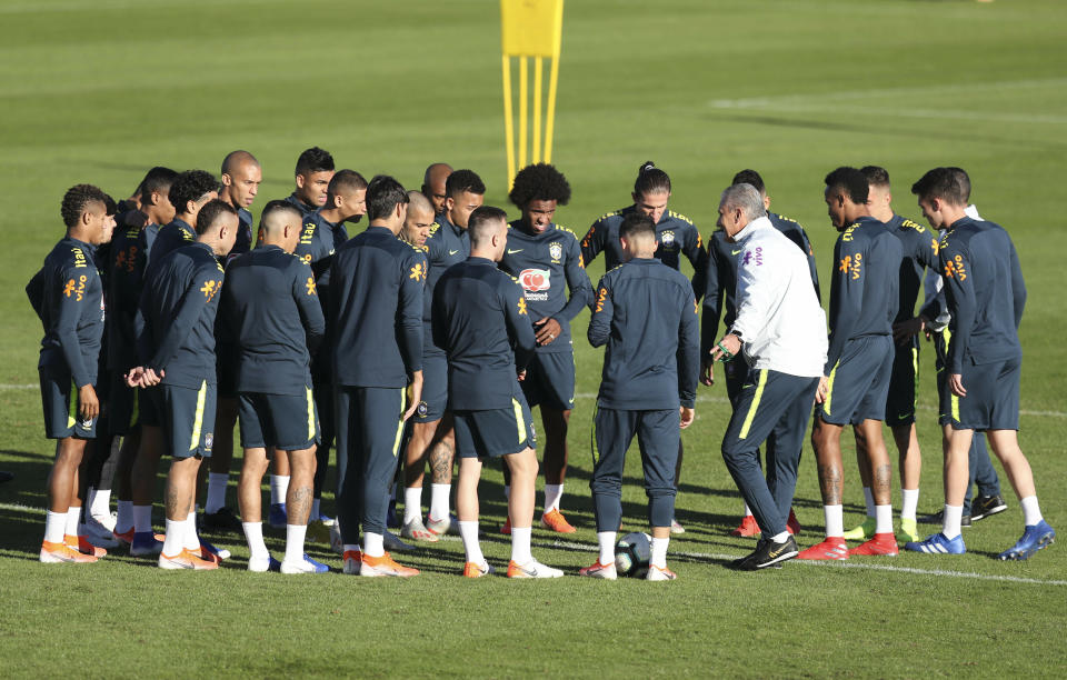 Brazil's coach Tite, third from right, gather his players during a training session in Porto Alegre, Brazil, Wednesday, June 26, 2019. Brazil will play Paraguay for a Copa America quarter-final match on June 27.(AP Photo/Natacha Pisarenko)