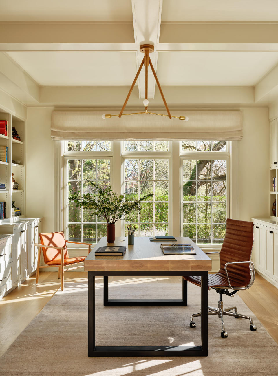 A small office with wooden flooring and greige high pile rug