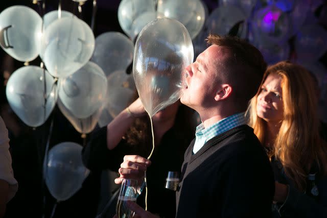 <p>Huge Galdones</p> A guest samples an edible helium balloon made by Grant Achatz
