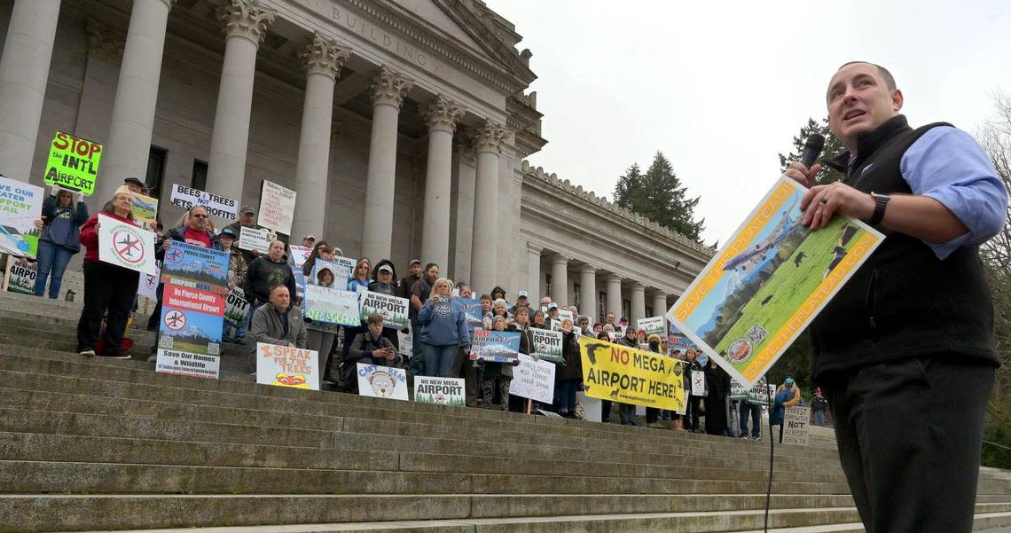 Orting Mayor Josh Penner speaks to a vocal crowd of over 100 people representing Thurston, Pierce, Mason and King counties gathered Wednesday, Jan. 25, 2023 on the state Capitol steps in Olympia to protest several potential airport sites targeted for their communities.