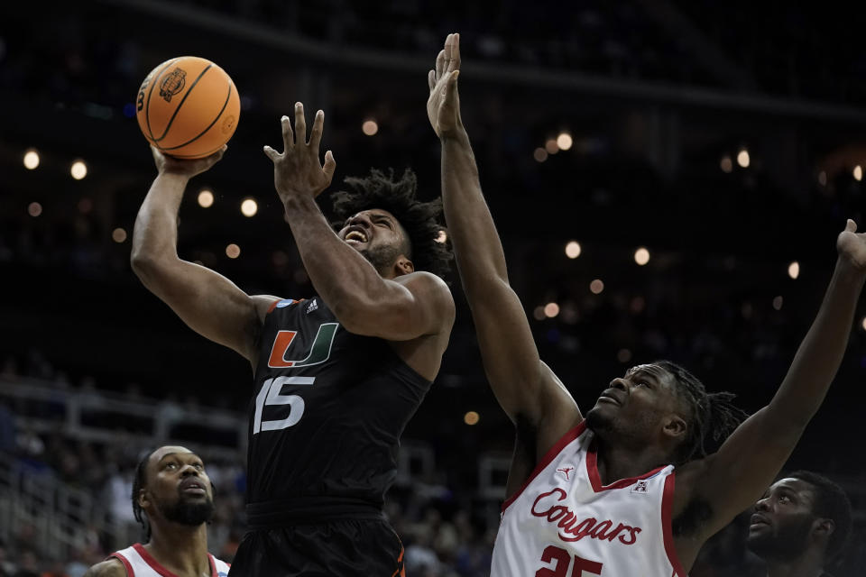 Miami forward Norchad Omier shoots over Houston guard Mylik Wilson in the second half of a Sweet 16 college basketball game in the Midwest Regional of the NCAA Tournament Friday, March 24, 2023, in Kansas City, Mo. (AP Photo/Charlie Riedel)